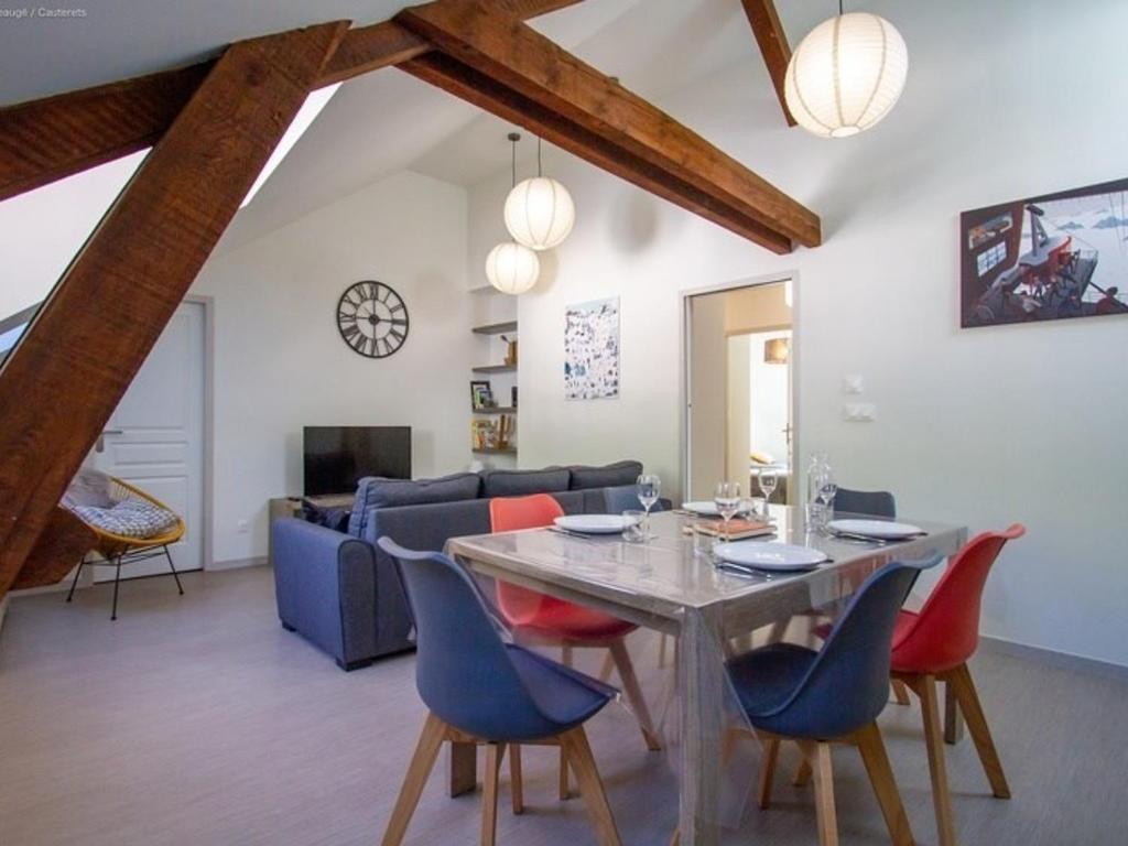a dining room and living room with a table and chairs at Charmant appart 2 ch, accueillant et équipé, à Cauterets - FR-1-812-60 in Cauterets