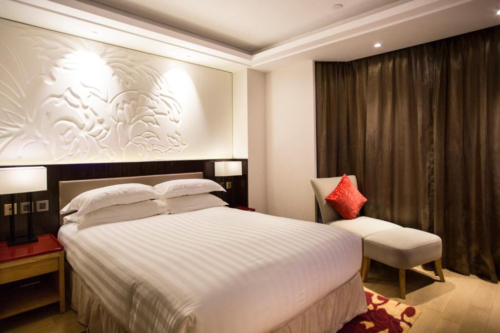 Katil atau katil-katil dalam bilik di Wharney Hotel
