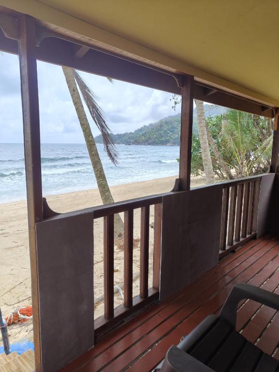 a balcony with a view of the beach at Permata Beach Chalet in Kampong Juara