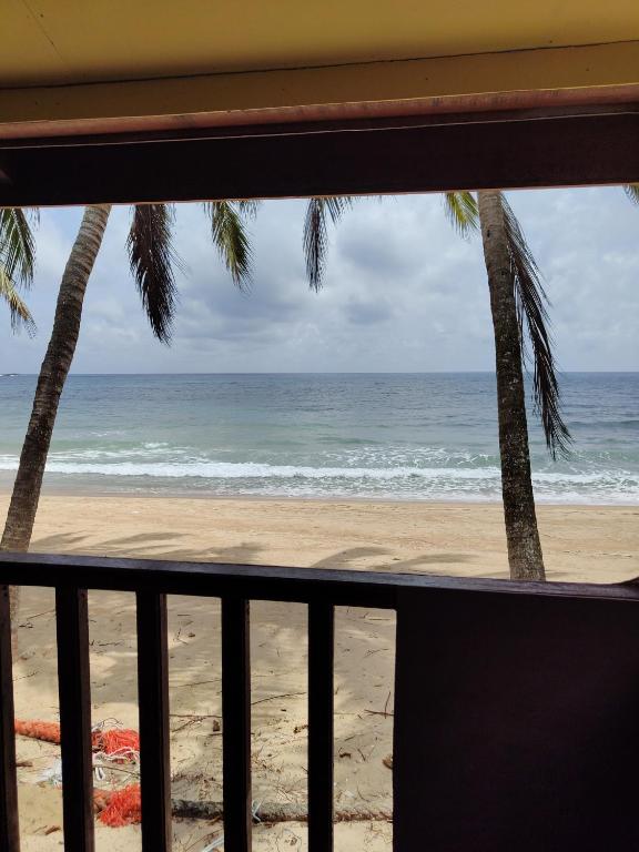 a view of the beach from a balcony at Permata Beach Chalet in Kampong Juara