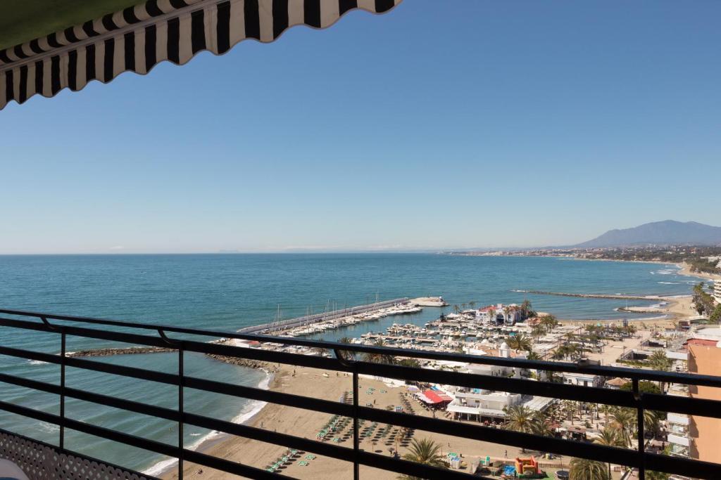 a view of the beach from a balcony at Apartamento Mediterraneo Side in Marbella