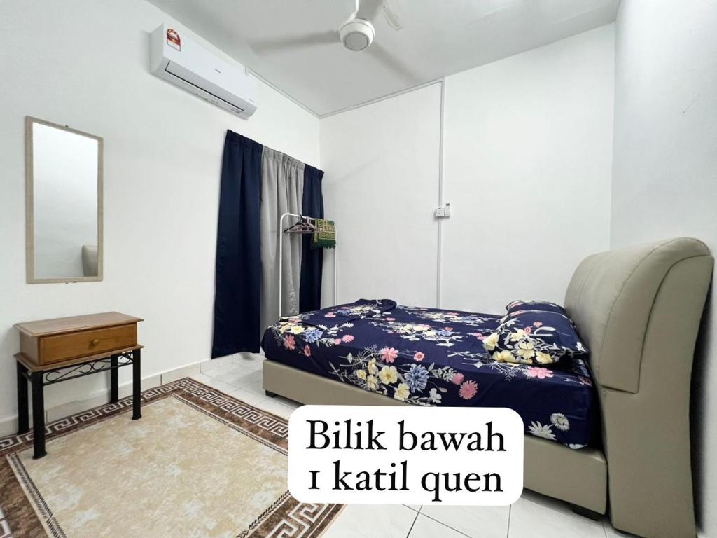 a bedroom with a bed and a chair and a mirror at Ciksiti homestay landed 05 in Kajang