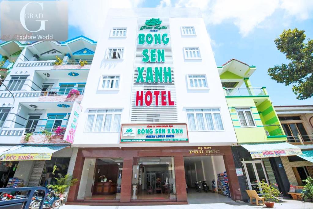 a large white building with a sign on it at Bong Sen Xanh Hotel in Cao Lãnh
