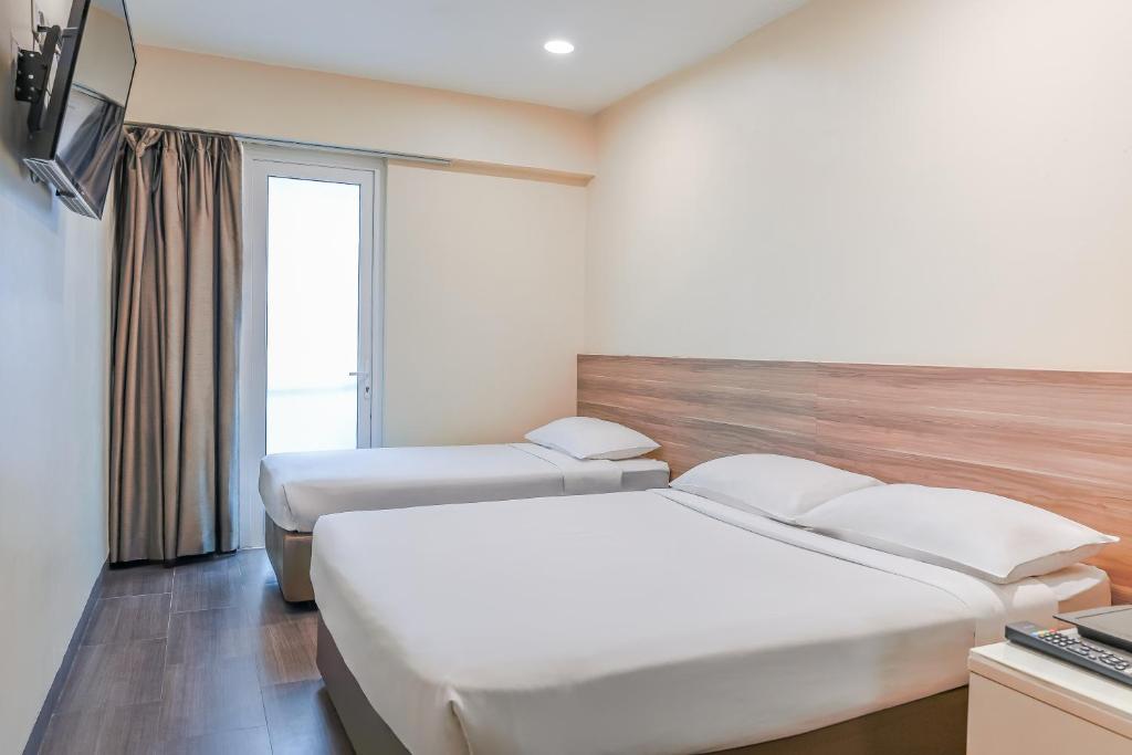 Postel nebo postele na pokoji v ubytování Hotel 81 Dickson