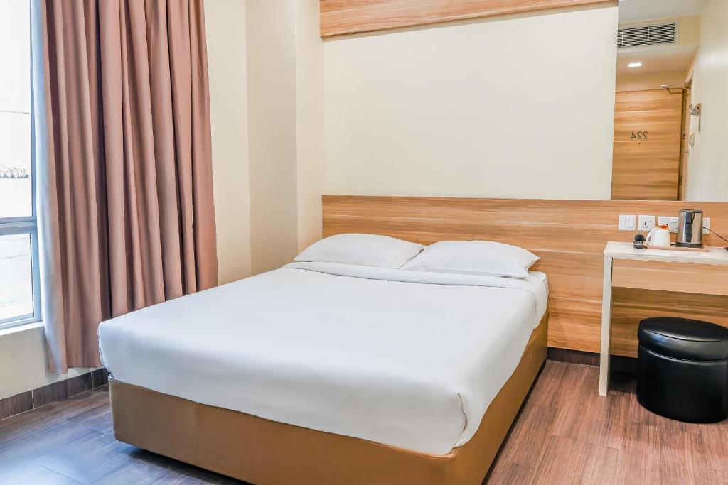 Postel nebo postele na pokoji v ubytování Hotel 81 Dickson