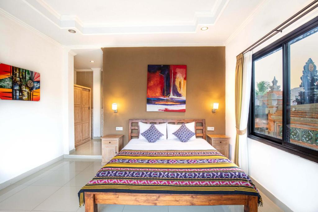 Postel nebo postele na pokoji v ubytování Warji House 1 Ubud Centre