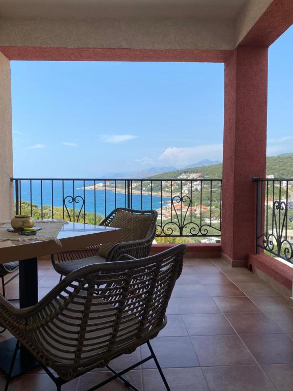 a balcony with chairs and a view of the ocean at Apart Bella Utjeha Sea View 68 qm in Utjeha