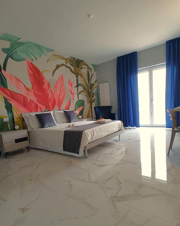 a bedroom with a bed with a mural of plants at Luxury Melo Apartment in Bari