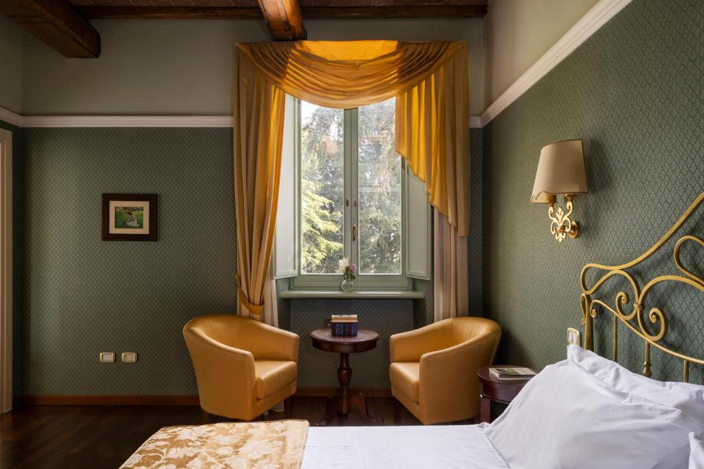 Postel nebo postele na pokoji v ubytování Relais Parco Dei Cavalieri Assisi