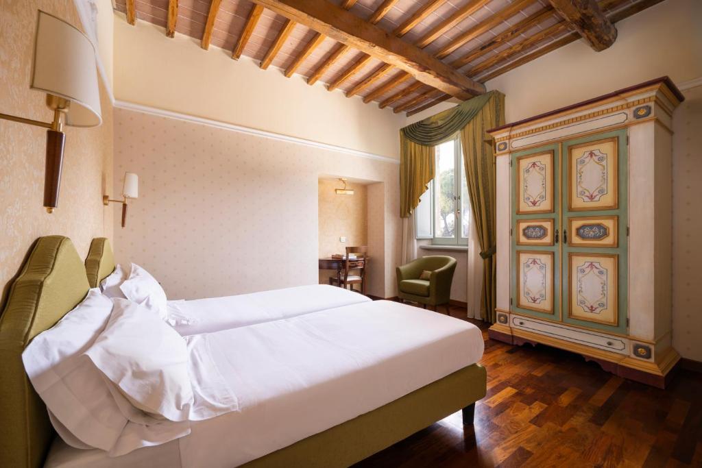 Postel nebo postele na pokoji v ubytování Relais Parco Dei Cavalieri Assisi