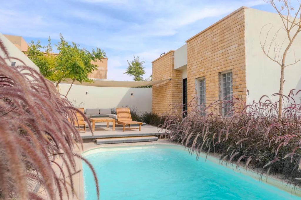 a swimming pool in the backyard of a house at Portal Chalets With Private Pool - Al-Rawda in Riyadh