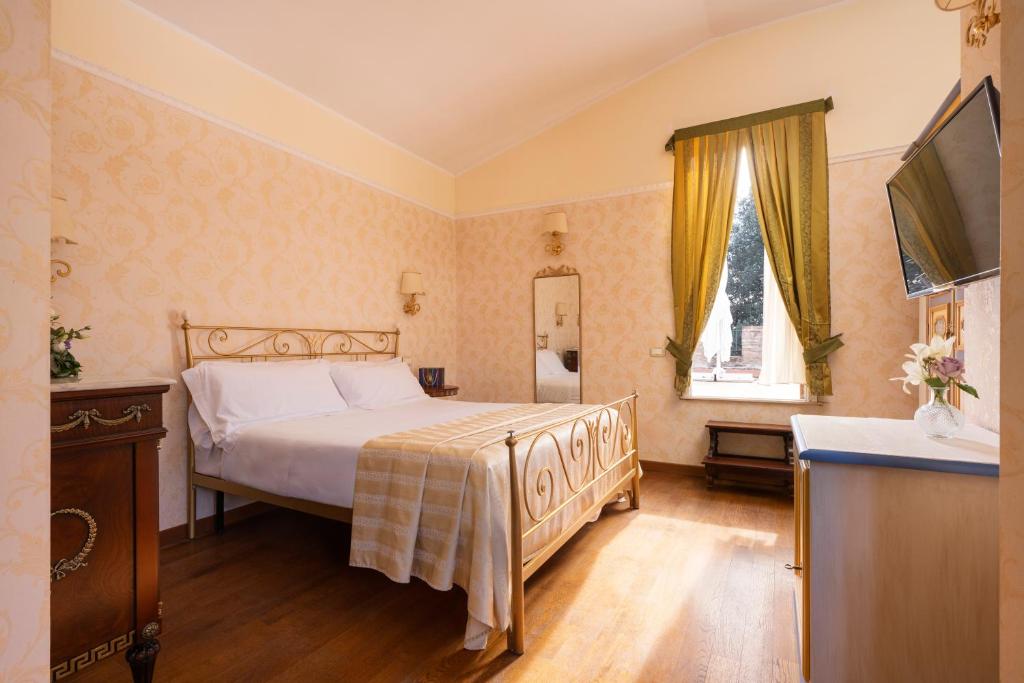 Postel nebo postele na pokoji v ubytování Relais Parco Dei Cavalieri Assisi
