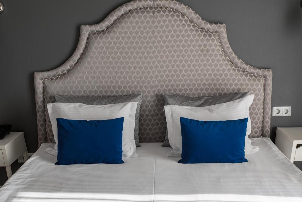 Postel nebo postele na pokoji v ubytování Rivoli Hotel
