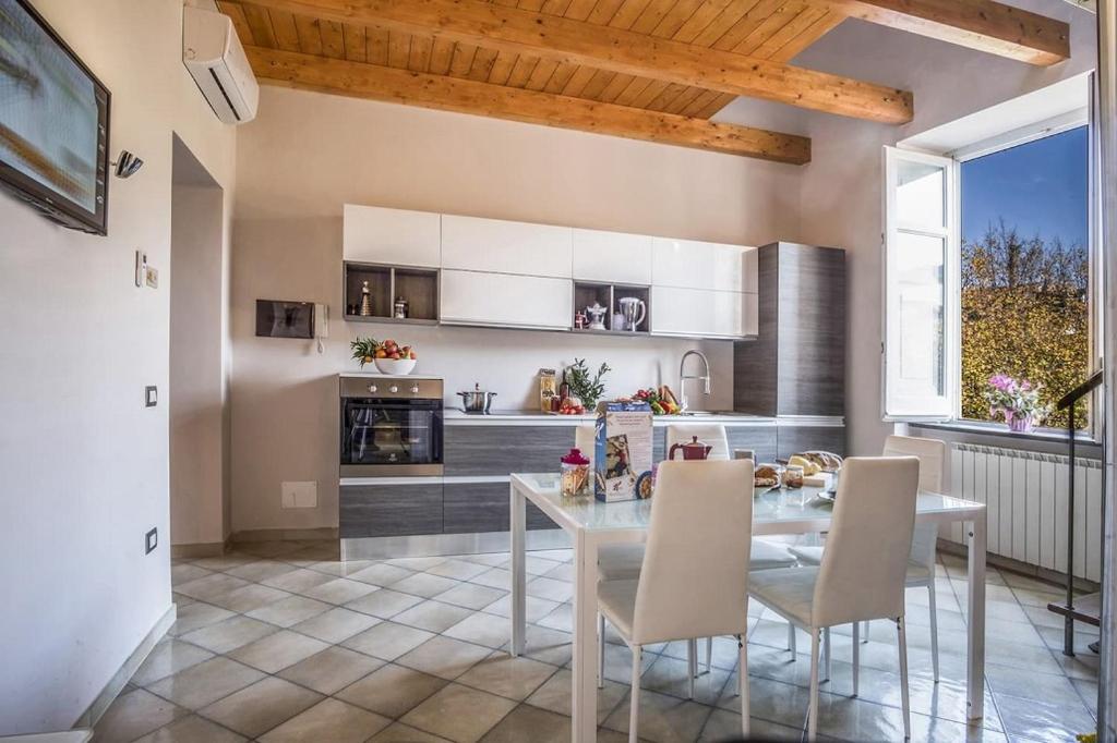 a kitchen and dining room with a table and chairs at Apartment Caruso in Sorrento