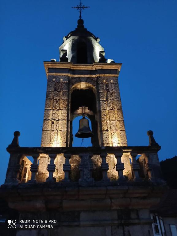 a bell tower of a building with a steeple at A casa da Igrexa in Ribadavia