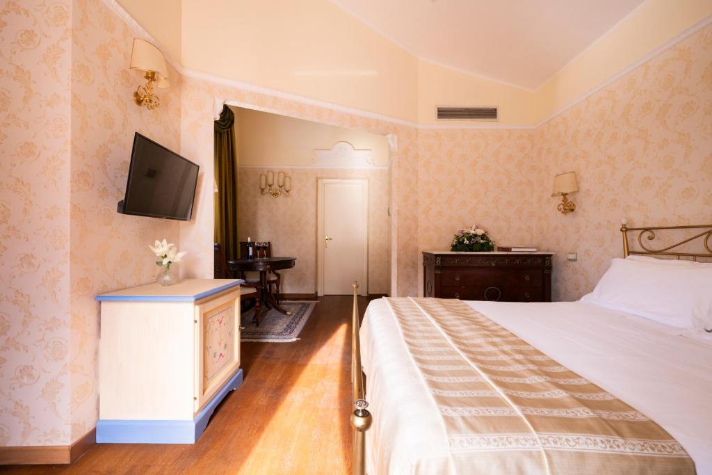 Postel nebo postele na pokoji v ubytování Relais Parco Dei Cavalieri Assisi