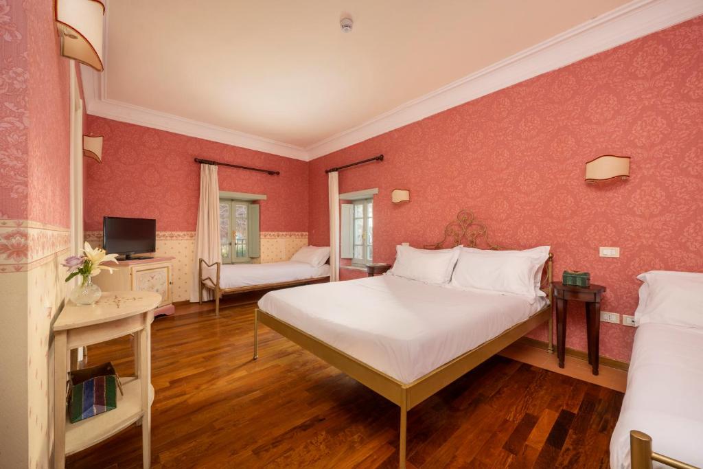 Postel nebo postele na pokoji v ubytování Relais Parco Dei Cavalieri Assisi