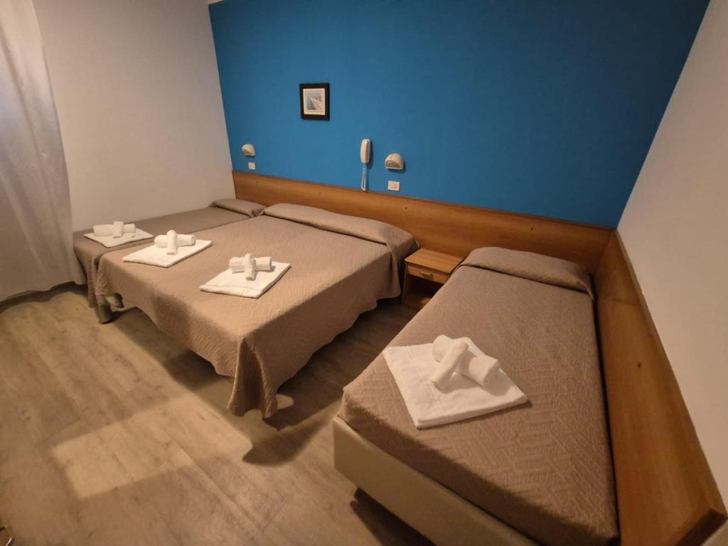 Postel nebo postele na pokoji v ubytování Hotel REX