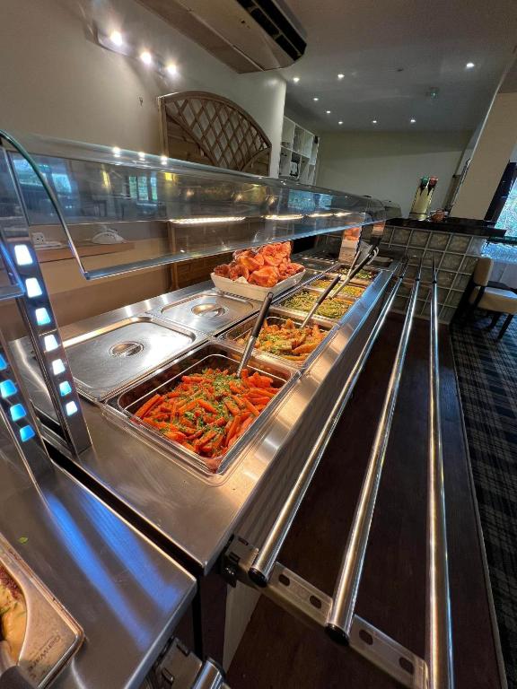 a buffet line with many different types of food at Bowood Park Hotel in Camelford