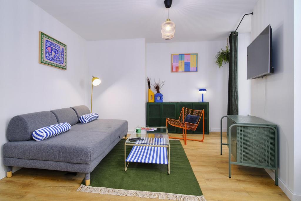 ヴィエンヌにあるLe Marty, T2 inoubliable, confort et styleのソファとテーブルのあるリビングルーム