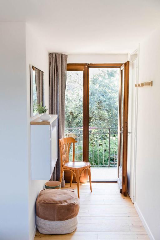 a living room with a chair and a window at BnB Casa Bellavista Sant Abbondio 6577 Ranzo in Gerra