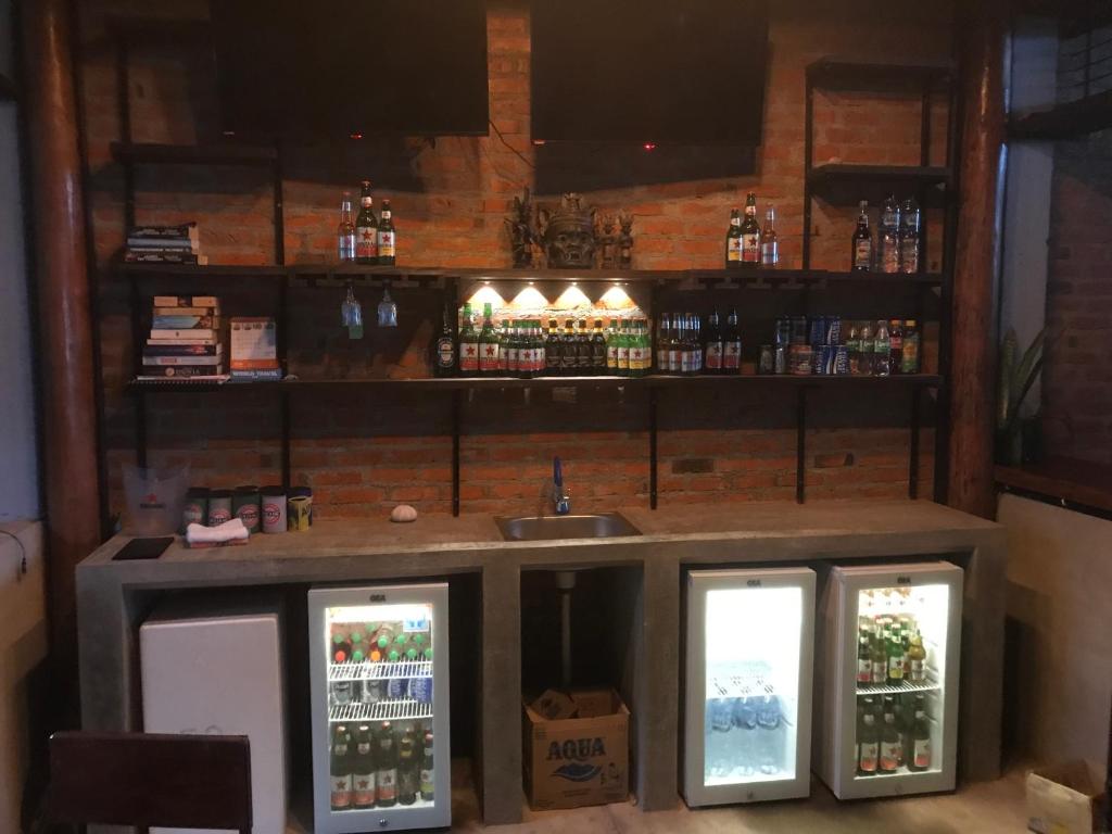 a bar with two refrigerators and a sink at Dolin Cottage in Hilibotodane