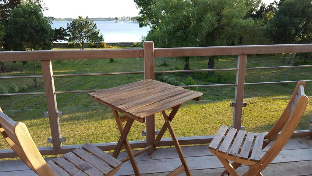 a wooden table and two chairs sitting on a porch at Manoir de Larmor in Vannes