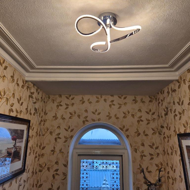 a ceiling light in a room with a window at Kintrae B&B in Buckie