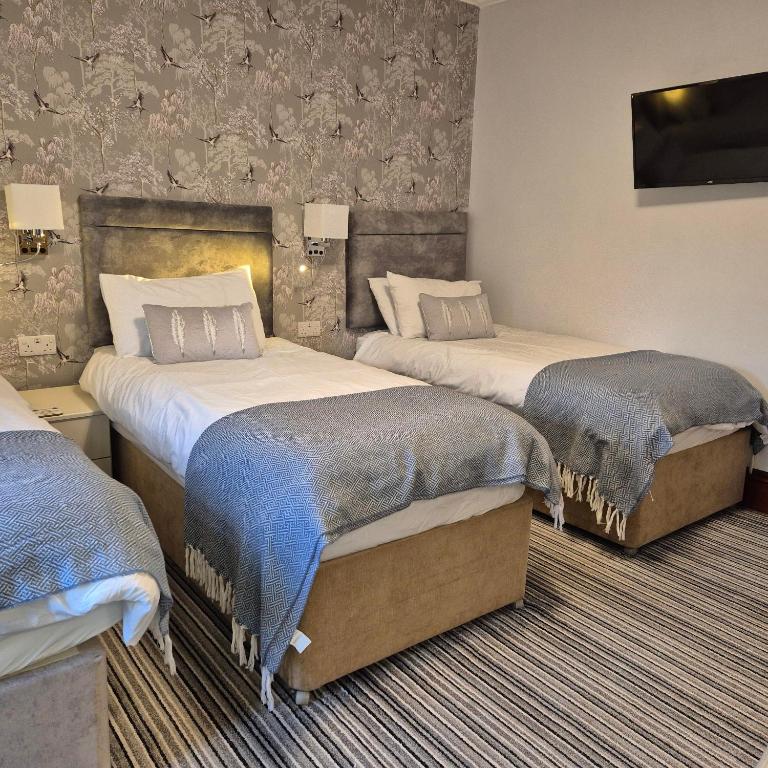 a hotel room with two beds in a room at Kintrae B&B in Buckie