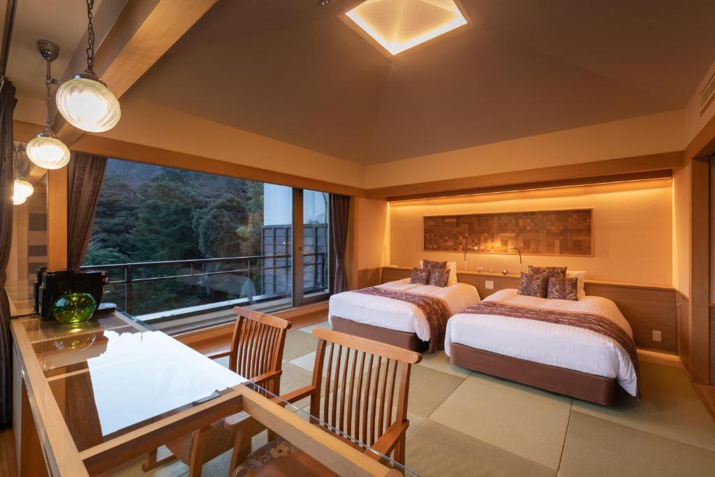 Postel nebo postele na pokoji v ubytování Hakone Kamon