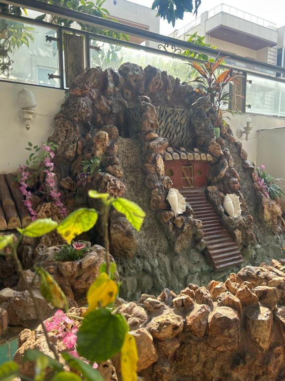 a building made out of rocks with stairs and plants at The Palace Inn - A boutique villa in Jaipur