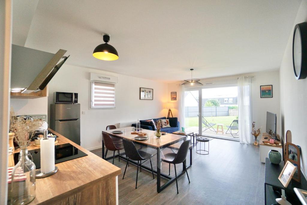 une cuisine et un salon avec une table et des chaises dans l'établissement L'horizon -parking, à Concarneau