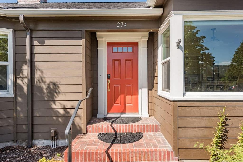 a red door on a house with a stoop at Sq Urban Retreat in Sequim