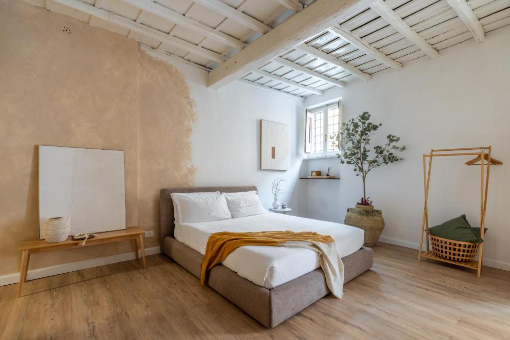 a bedroom with a large white bed and a window at Eos Retreat in Trastevere with pool in Rome