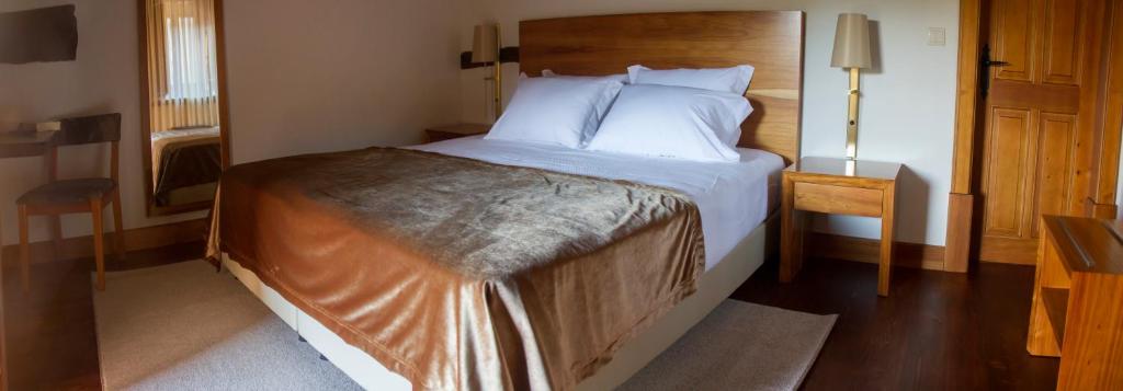 Uma cama ou camas num quarto em Refgios do Pinhal