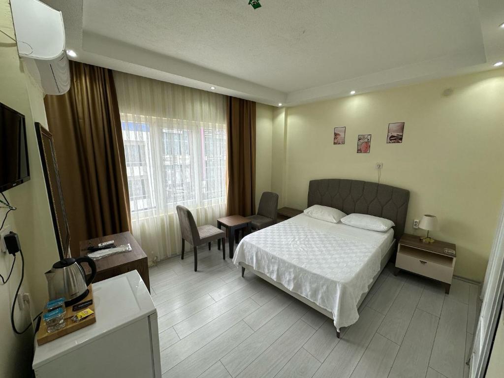 a hotel room with a bed and a table at NAVAL HOTEL YALOVA in Yalova