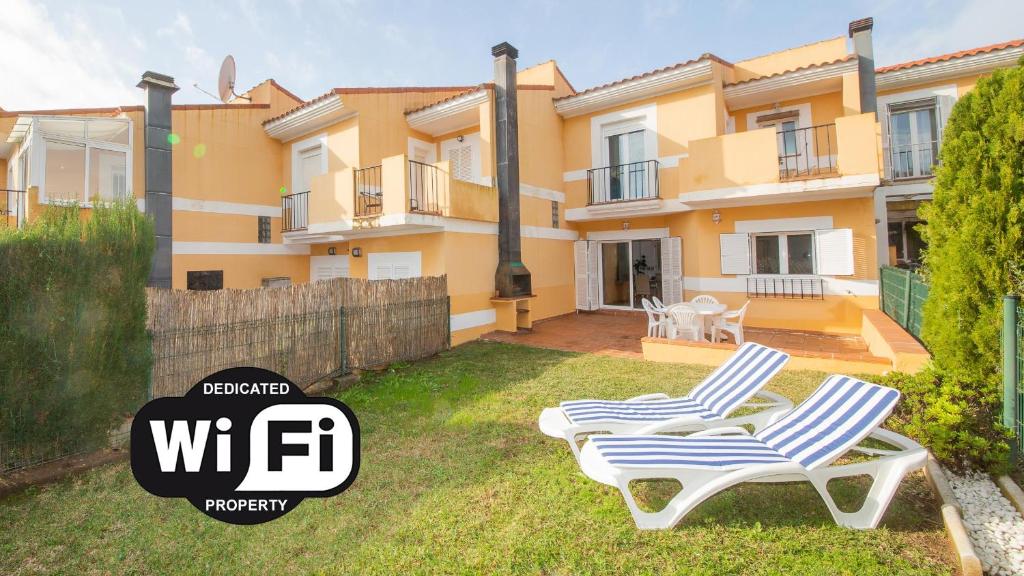 two chairs in the backyard of a house at Villas del Golf 27 in Manilva