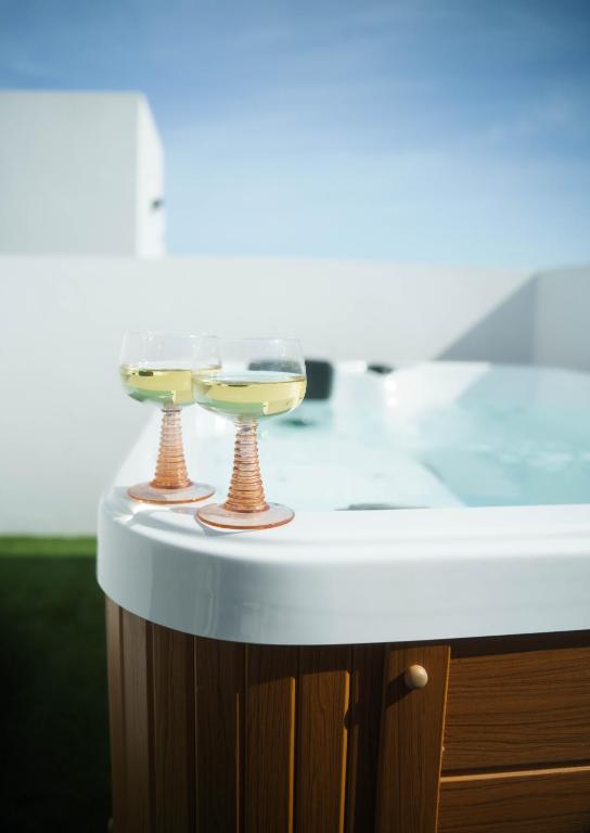 a white counter with two glasses on top of it at Emerald Suite Plaza in Corralejo