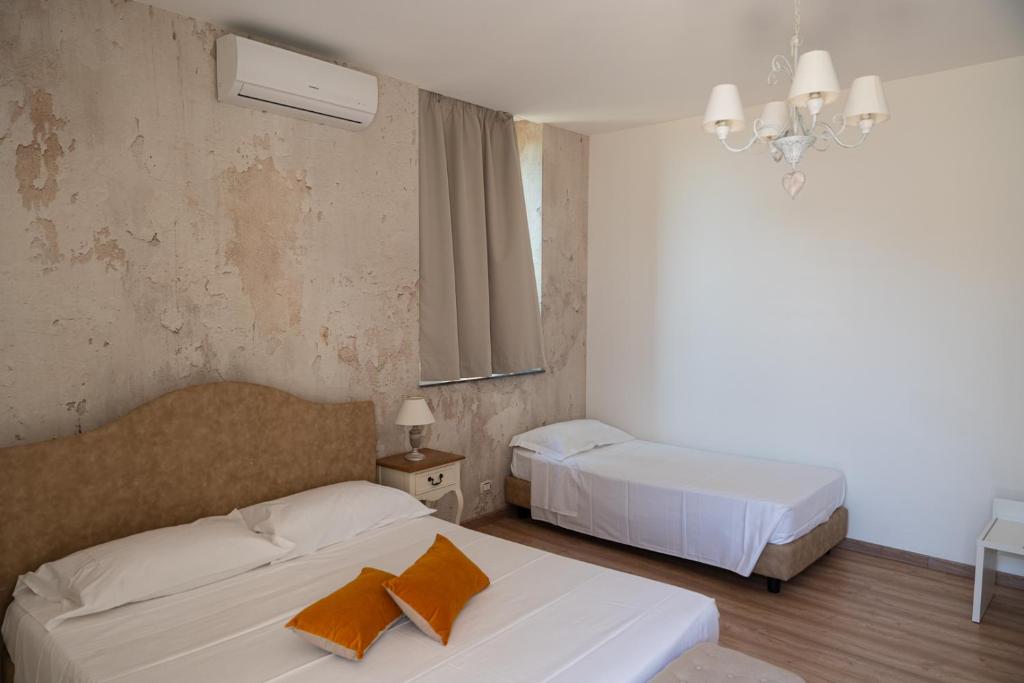 Posteľ alebo postele v izbe v ubytovaní B&B Donna Cinzia