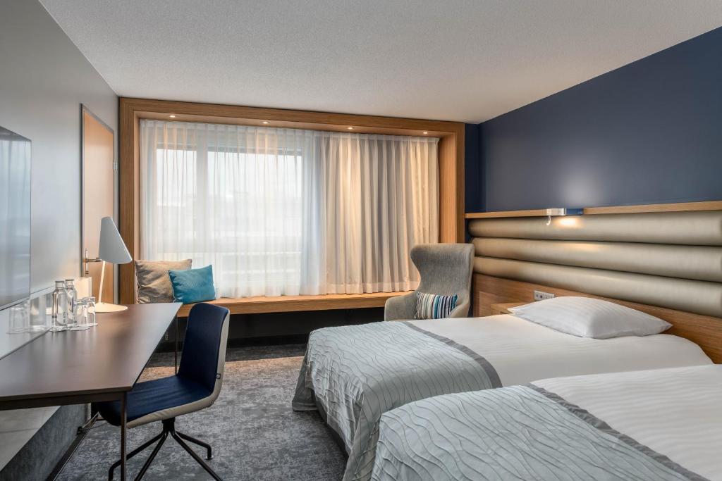 Postel nebo postele na pokoji v ubytování Mövenpick Hotel Lausanne