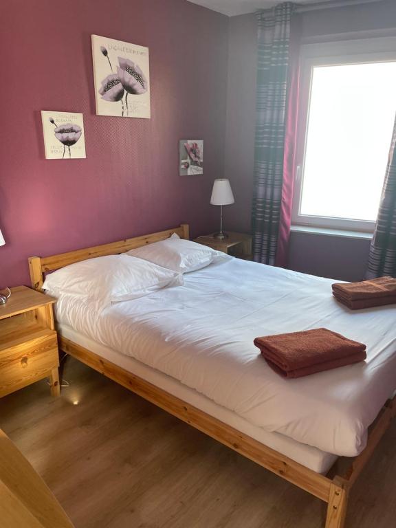 Postel nebo postele na pokoji v ubytování L'Hôtel du Mouton blanc