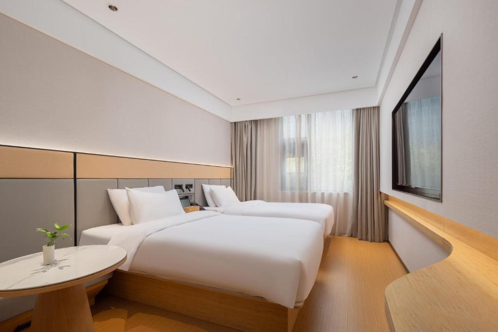 Postel nebo postele na pokoji v ubytování Bo Ting Hotel泊庭酒店