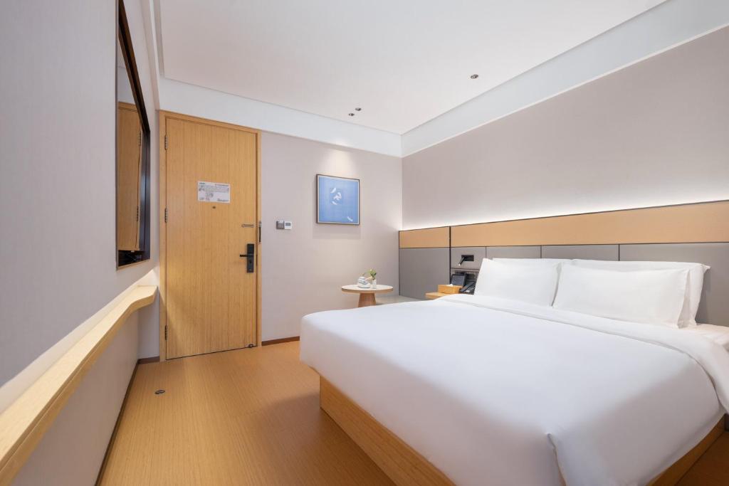 Postel nebo postele na pokoji v ubytování Bo Ting Hotel泊庭酒店