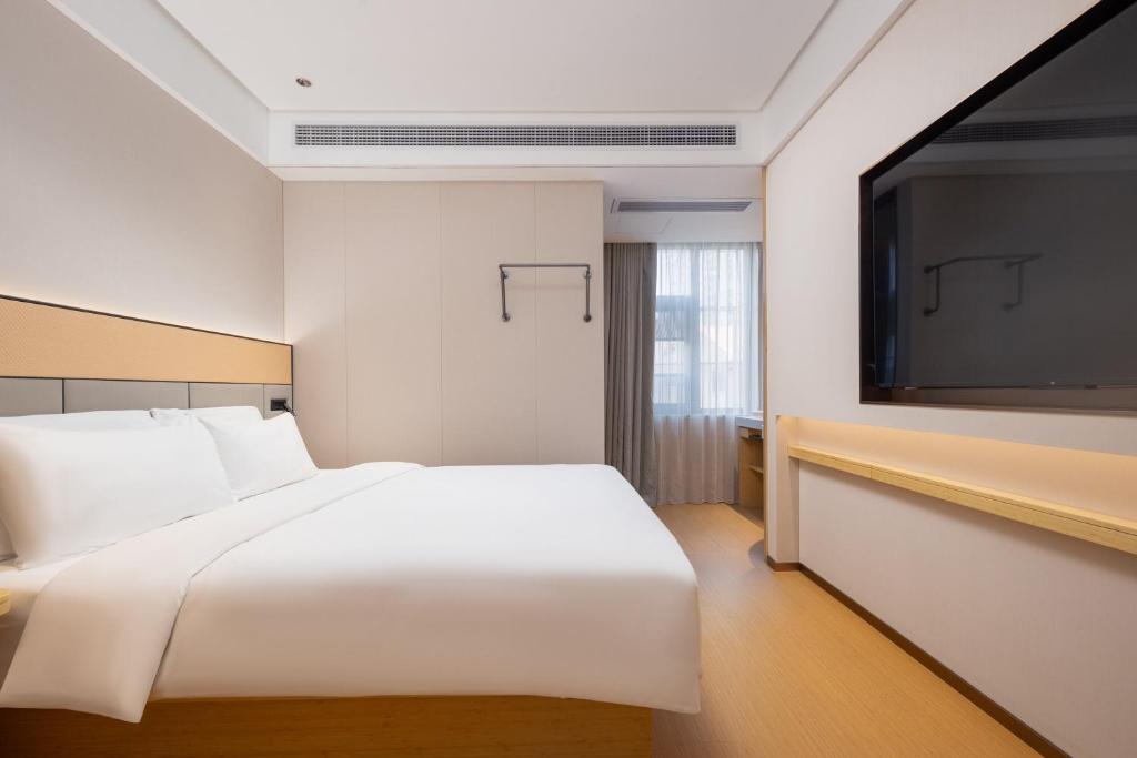 Postel nebo postele na pokoji v ubytování Bo Ting Hotel泊庭酒店