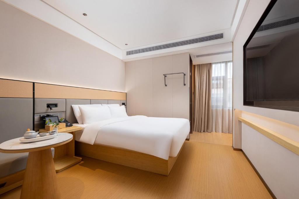 Postel nebo postele na pokoji v ubytování Bo Ting Hotel泊庭酒店