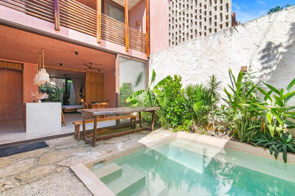 a house with a swimming pool next to a building at Private & Modern 2-BR Villa of La Veleta in Tulum