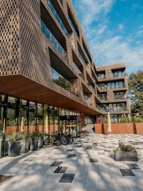 a building with bikes parked in front of it at GRANO APARTHOTEL Ustronie Morskie in Ustronie Morskie