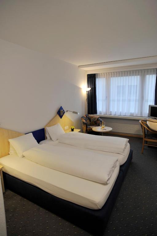 Postel nebo postele na pokoji v ubytování Hotel Blumenstein Self-Check In