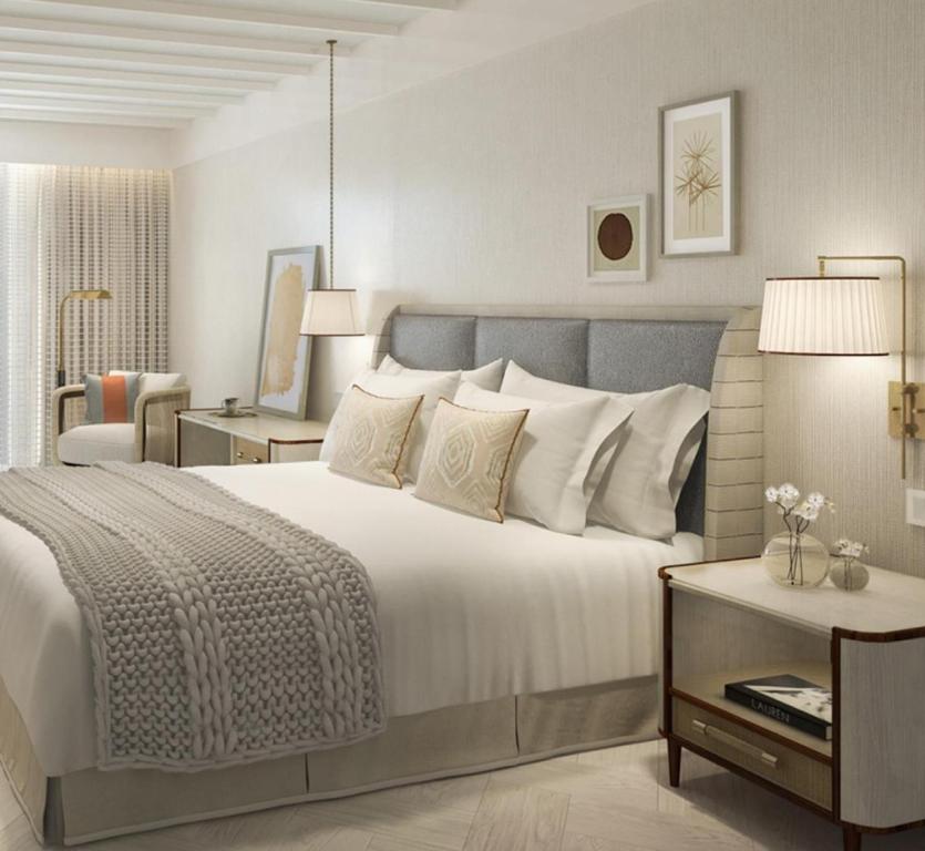 a bedroom with a large white bed and a table at Amadria Park Grand Hotel 4 Opatijska Cvijeta in Opatija