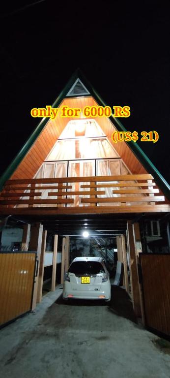 a car parked in a garage with a car parked under it at cinnamon avenue cabanas in Negombo